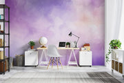 Watercolour wall mural in purple and pastel tones, decorating a modern home office with a minimalist desk, chair and bookshelves for a stylish and inspiring workspace.