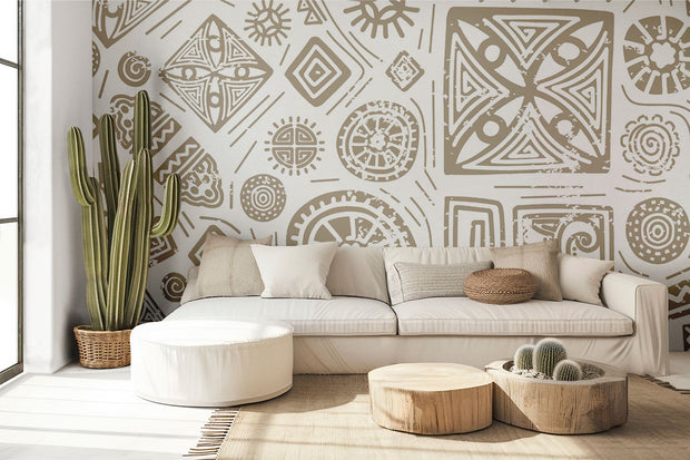 Modern tribal geometric wall mural in gold and white with abstract patterns, styled in contemporary living room with sofa.