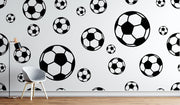 Modern black and white soccer ball wall mural with bold soccer patterns, perfect for sports-themed decor in homes or offices.