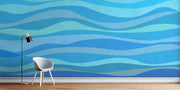 Modern blue wave wall mural featuring abstract wave patterns in various shades of blue, enhancing the decor of a living room.