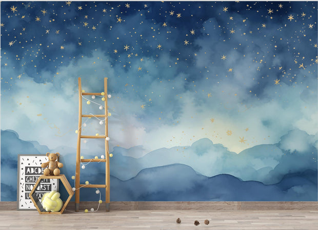 Starry night wall mural featuring a watercolor style sky in deep blue tones with golden stars, decorating a cozy children’s playroom.