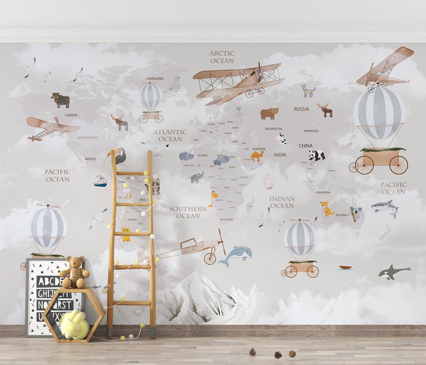 Whimsical world map wall mural featuring illustrated continents, animals, vintage airplanes, and hot air balloons, styled in a modern kids' room.