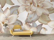 Golden floral wall mural with intricate oversized flowers and leaves in a modern living room with yellow sofa.