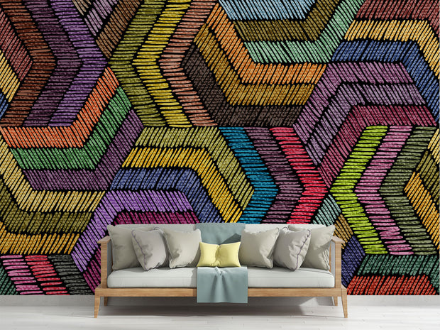 Modern rainbow geometric wall mural with textured chevron pattern, styled in minimalist living room with grey sofa.