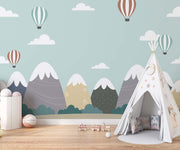 Scandinavian-style mountain nursery wallpaper with floating hot air balloons decorating kids room.