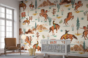 Wild West cowboy wall mural featuring galloping horses, cowboys, cacti, and Western landscapes in a vintage-style wallpaper design.