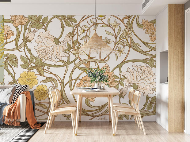 Art Nouveau botanical wall mural with flowing floral patterns in beige, sage green, and gold tones, styled in a cosy dining room with wooden furniture.