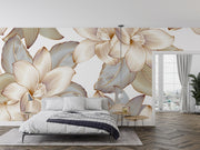 Golden floral wall mural with intricate oversized flowers and leaves in a modern bedroom with neutral decor and hardwood flooring.