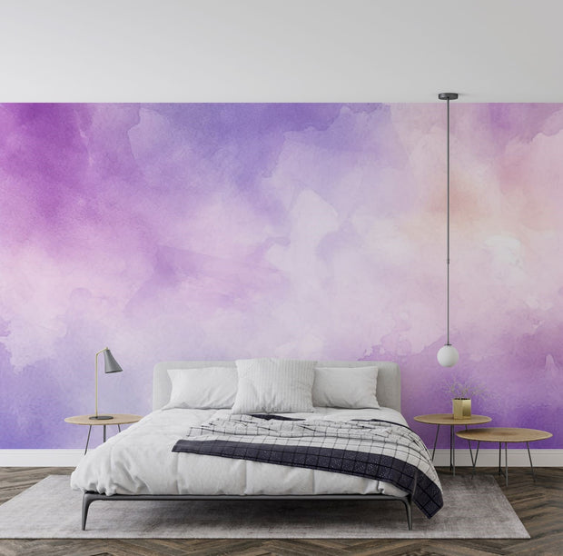 Watercolour-inspired wall mural with rich purple and pastel tones, decorating a modern bedroom with a minimalist bed, pendant light and side tables.