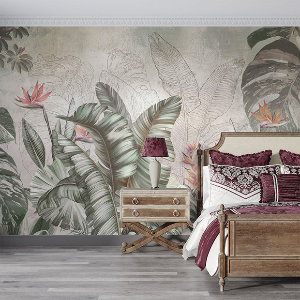 Elegant tropical wall mural with monstera leaves and birds of paradise flowers in sage green and coral, styled in a bedroom.