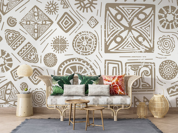 Modern tribal geometric wall mural in gold and white with abstract patterns, styled in contemporary living room with sofa.