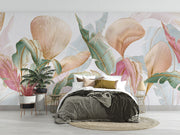 Pastel tropical leaf wall mural with oversized botanical patterns in soft pink, teal, and gold tones, perfect for modern, boho, and tropical-inspired interiors.