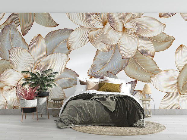 Golden floral wall mural with intricate oversized flowers and leaves in a modern bedroom with neutral decor.