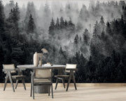 Foggy forest wall mural with pine trees enveloped in soft mist, creating a peaceful and elegant backdrop for any room.