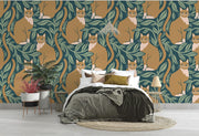 Whimsical wall mural featuring orange cats surrounded by green leaves, adding playful charm to a modern bedroom.