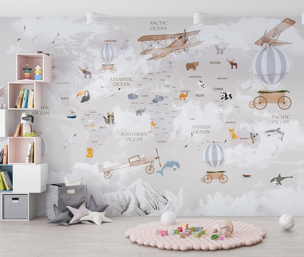 Whimsical world map wall mural featuring illustrated continents, animals, vintage airplanes, and hot air balloons, styled in a modern kids' room.