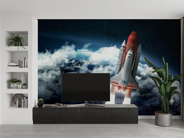 Wall mural of a space shuttle launching into orbit with Earth and clouds in the background; decorating a living room.