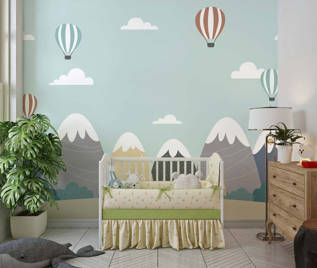 Scandinavian-style mountain nursery wallpaper with floating hot air balloons decorating a nursery.