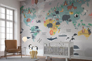 Illustrated kids world map wall mural featuring continents, oceans, animals, and landmarks in a playful and educational design.