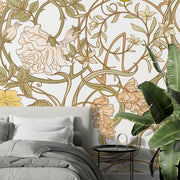 Art Nouveau botanical wall mural with flowing floral patterns in beige, sage green, and gold tones, styled in a modern bedroom.