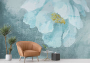 A modern living room with a Blue Floral Watercolor Wall Mural, featuring a delicate oversized flower in teal and gold hues. Creating a cosy and elegant space with a soft, artistic ambience.