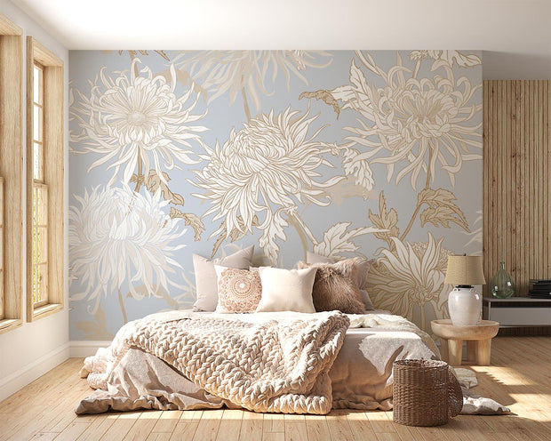 Elegant blue floral wall mural with intricate beige and gold chrysanthemums, styled in a cosy bedroom.