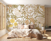 Art Nouveau botanical wall mural with flowing floral patterns in beige, sage green, and gold tones, styled in a cosy bedroom.