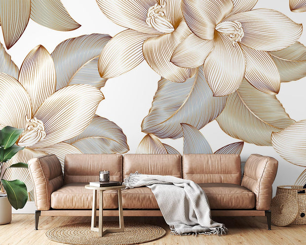 Golden floral wall mural with intricate oversized flowers and leaves in a modern living room.