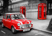 Wall mural showcasing a vibrant red Mini Cooper and iconic red telephone boxes in a black-and-white London city scene.