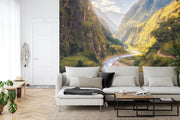 Majestic valley wall mural with green mountains, winding river, and sunlight, perfect for nature-inspired bedroom or living room décor.