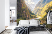 Majestic valley wall mural with green mountains, winding river, and sunlight, perfect for nature-inspired bedroom or living room décor.