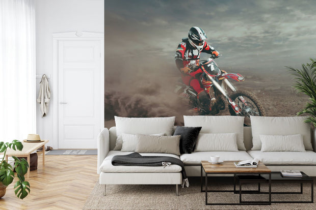 Wall mural featuring a dirt bike racer in mid-action on a desert track, surrounded by dust and rugged terrain.