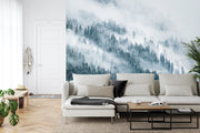 Snowy forest wall mural featuring a serene winter landscape with evergreen trees, snow, and soft mist, perfect for peaceful living room decor.