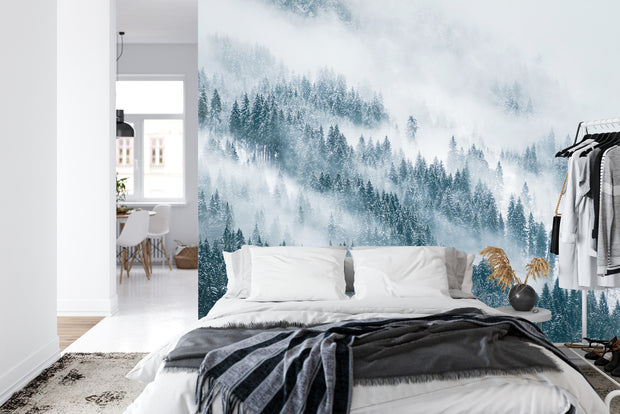 Snowy forest wall mural featuring a serene winter landscape with evergreen trees, snow, and soft mist, perfect for peaceful bedroom decor.