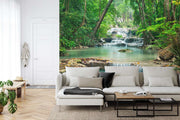 Wall mural of a lush green forest with cascading waterfalls, creating a peaceful ambiance in a modern room.