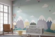 Scandinavian-style mountain nursery wallpaper with floating hot air balloons decorating nursery.