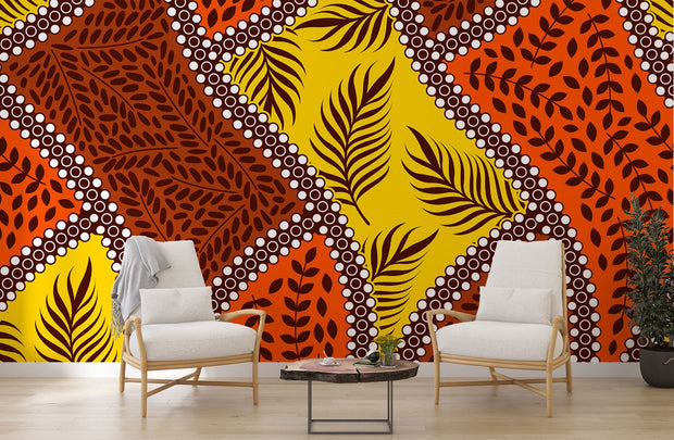 Bold tropical wall mural with vibrant orange, yellow, and brown leaf patterns, accented with white dots, perfect for boho and eclectic interior decor.